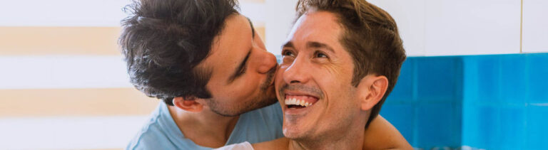 Happy gay male couple embrace