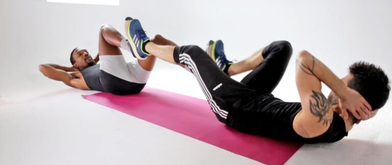 Happy couple performs bicycle crunches